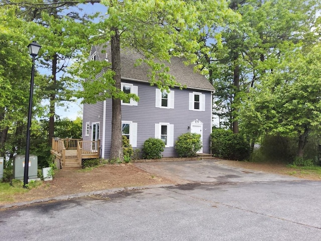 31 Harvard Ct, Dracut, MA 01826 - colonial home with a wooden deck and roof with shingles