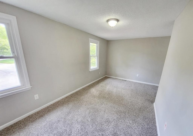31 Harvard Ct, Dracut, MA 01826 - carpeted empty room featuring a textured ceiling and baseboards