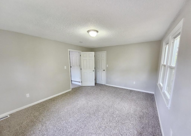 31 Harvard Ct, Dracut, MA 01826 - empty room featuring carpet flooring, baseboards, and a textured ceiling