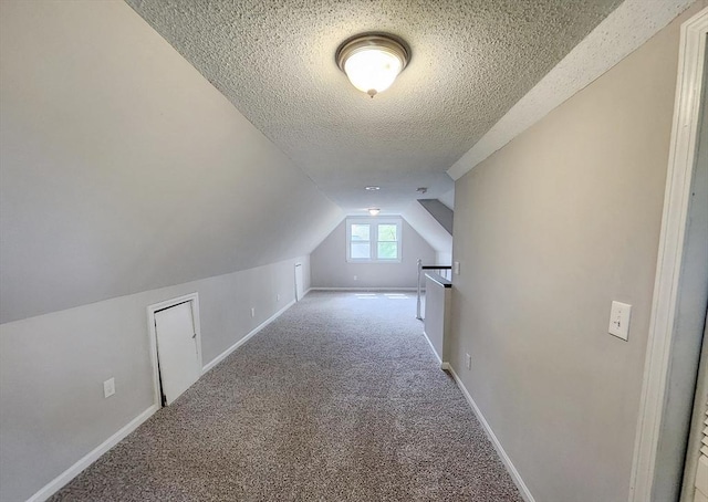 31 Harvard Ct, Dracut, MA 01826 - bonus room with a textured ceiling, carpet floors, vaulted ceiling, and baseboards
