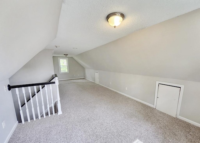 31 Harvard Ct, Dracut, MA 01826 - bonus room with carpet flooring, baseboards, vaulted ceiling, and a textured ceiling