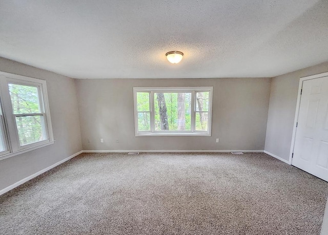 31 Harvard Ct, Dracut, MA 01826 - carpeted spare room with plenty of natural light, baseboards, and a textured ceiling