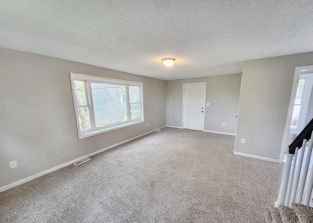 31 Harvard Ct, Dracut, MA 01826 - carpeted spare room featuring a textured ceiling, plenty of natural light, and baseboards