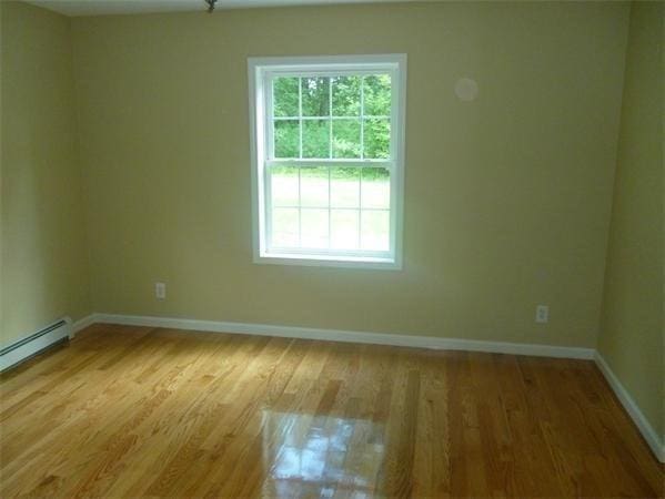 97 N Row Rd, Sterling, MA 01564 - spare room featuring healthy amount of natural light, light wood finished floors, and baseboard heating