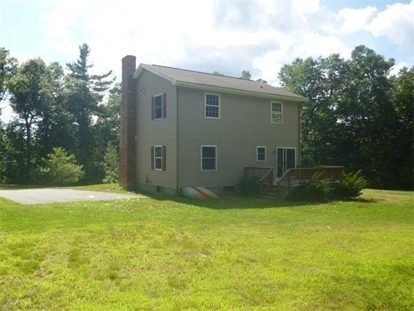 97 N Row Rd, Sterling, MA 01564 - back of house featuring a chimney, a wooden deck, and a yard