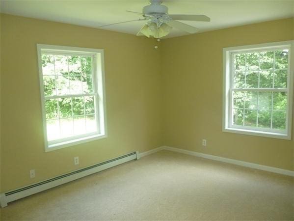 97 N Row Rd, Sterling, MA 01564 - unfurnished room featuring baseboard heating, a ceiling fan, healthy amount of natural light, and light colored carpet