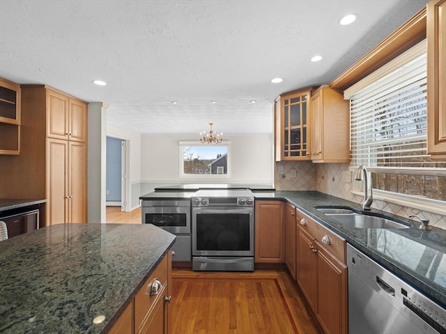 kitchen with sink, wood-type flooring, stainless steel appliances, and a wealth of natural light