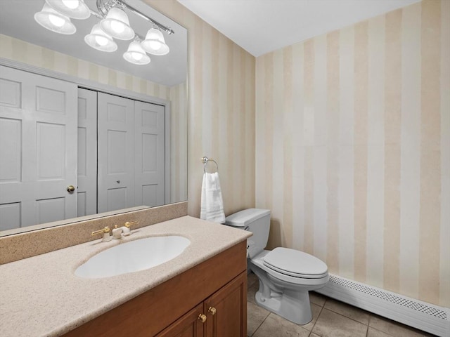 bathroom with toilet, vanity, tile patterned flooring, an inviting chandelier, and a baseboard radiator