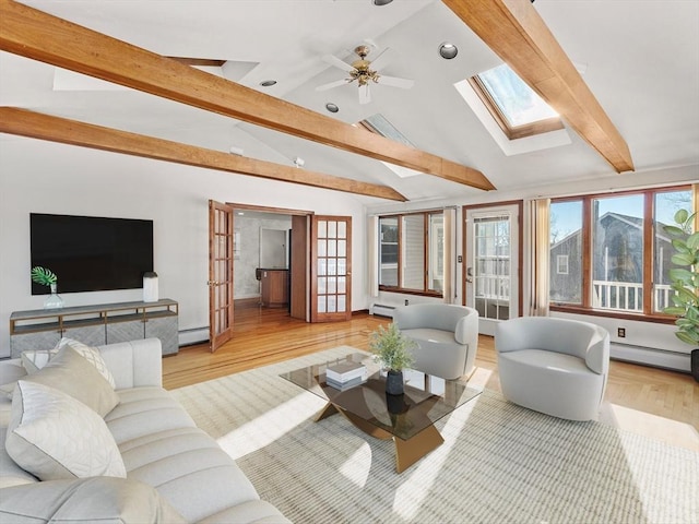 living room featuring baseboard heating, lofted ceiling with skylight, french doors, and light hardwood / wood-style flooring