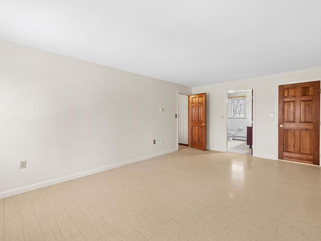 unfurnished room featuring baseboard heating