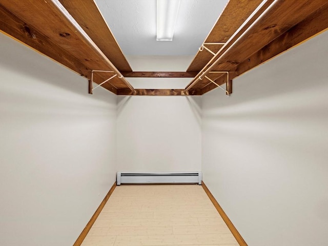 spacious closet featuring a baseboard heating unit