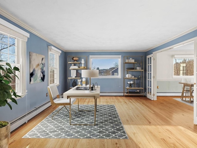 office area featuring baseboard heating, wood-type flooring, and crown molding