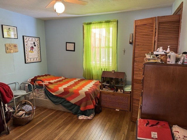 bedroom with wood-type flooring and ceiling fan