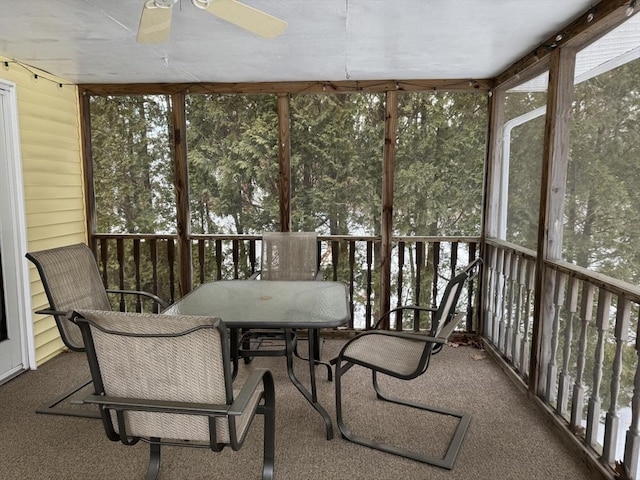 sunroom / solarium featuring a ceiling fan