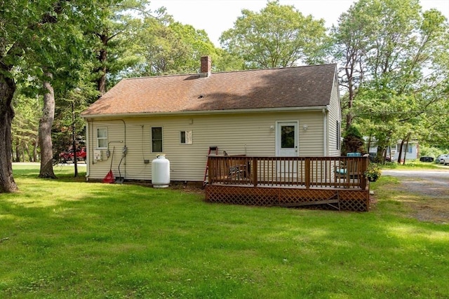 23 Mohawk St, Bellingham, MA 02019 - back of property featuring a wooden deck, a yard, a chimney, and roof with shingles