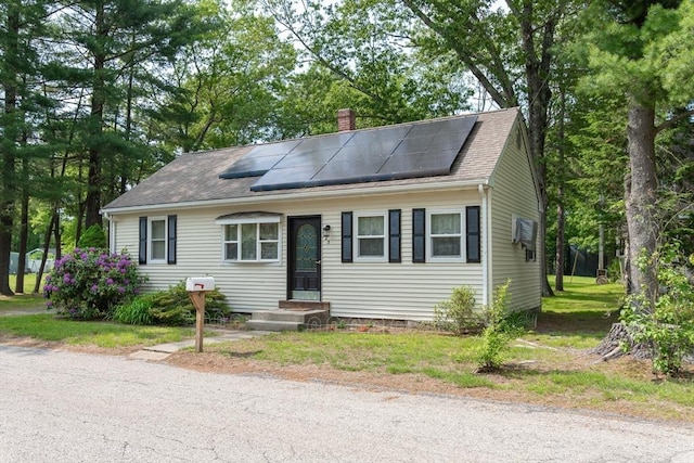 23 Mohawk St, Bellingham, MA 02019 - view of front of home featuring a chimney, solar panels, and roof with shingles