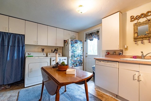 23 Mohawk St, Bellingham, MA 02019 - kitchen featuring white appliances, washer and dryer, light countertops, a sink, and white cabinetry