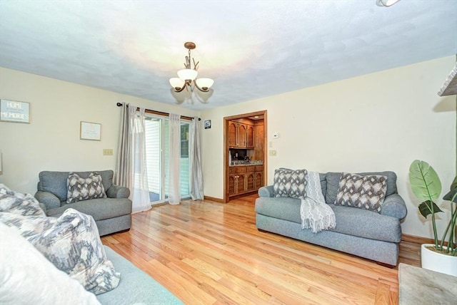 11 Balmoral Dr, Methuen, MA 01844 - living room with a chandelier, light wood-type flooring, and baseboards