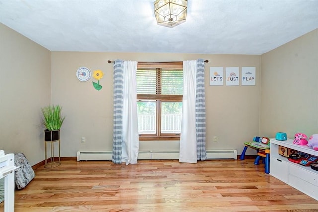 11 Balmoral Dr, Methuen, MA 01844 - game room featuring light wood-type flooring, baseboards, and a baseboard radiator