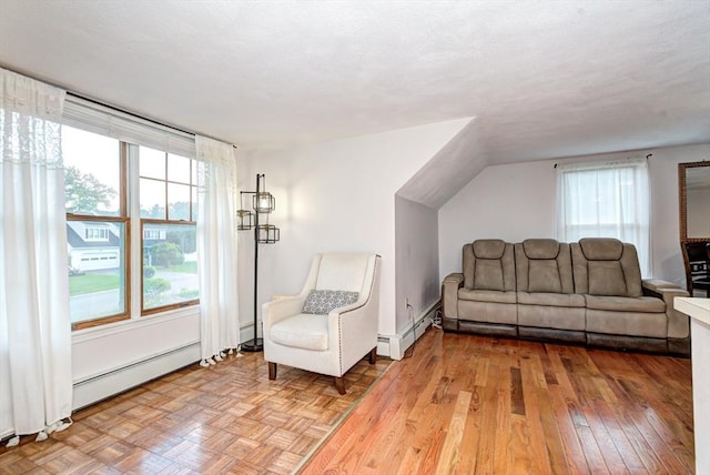 11 Balmoral Dr, Methuen, MA 01844 - living area with a baseboard heating unit, light wood-style flooring, and vaulted ceiling