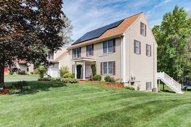 11 Balmoral Dr, Methuen, MA 01844 - colonial house featuring a front yard, solar panels, stairs, and roof with shingles