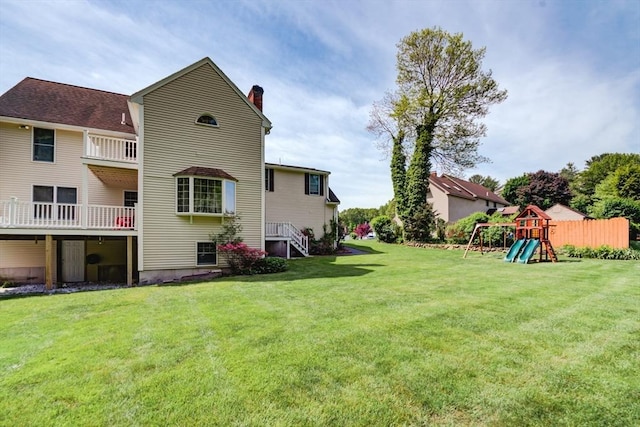 11 Balmoral Dr, Methuen, MA 01844 - back of property featuring a playground, a lawn, and a chimney
