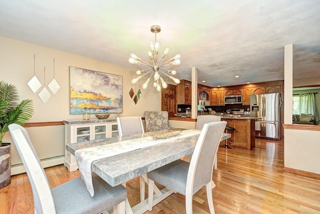11 Balmoral Dr, Methuen, MA 01844 - dining room featuring light wood-style flooring, a chandelier, and baseboards