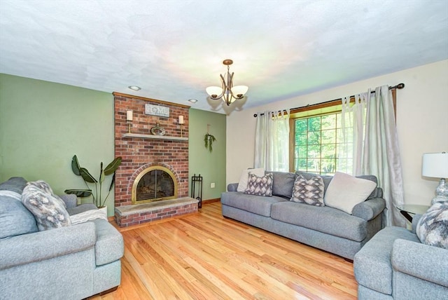 11 Balmoral Dr, Methuen, MA 01844 - living room featuring wood finished floors, a chandelier, and a fireplace