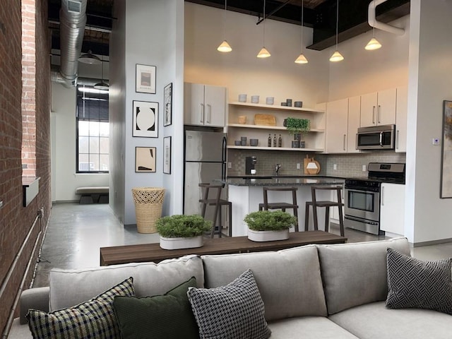 160 Water St Unit 212, Williamstown, MA 01267 - living area with a high ceiling and brick wall