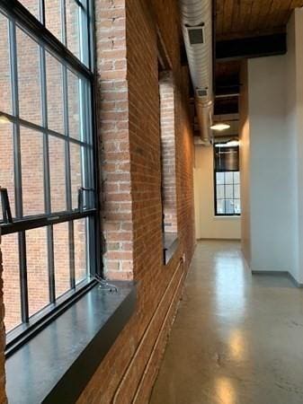 160 Water St Unit 212, Williamstown, MA 01267 - corridor featuring brick wall, concrete flooring, and wood ceiling