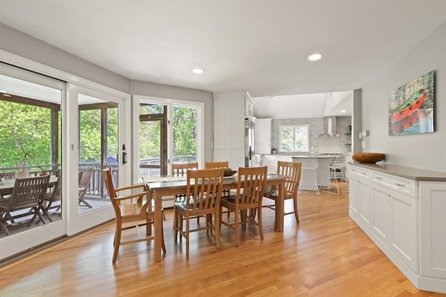 dining space featuring light wood-type flooring and recessed lighting