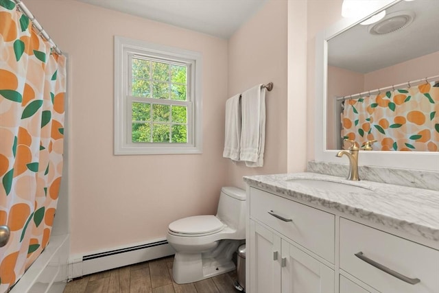 bathroom with a baseboard radiator, toilet, vanity, wood finished floors, and shower / bath combo with shower curtain