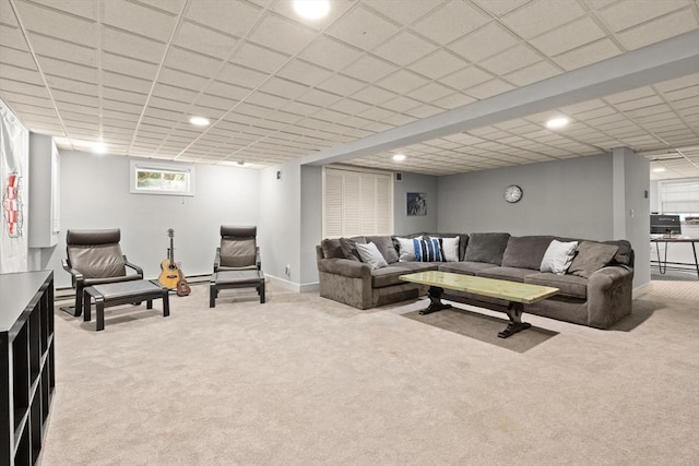 living room featuring light colored carpet, baseboards, recessed lighting, and a drop ceiling