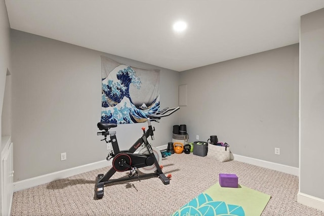workout room featuring baseboards and carpet