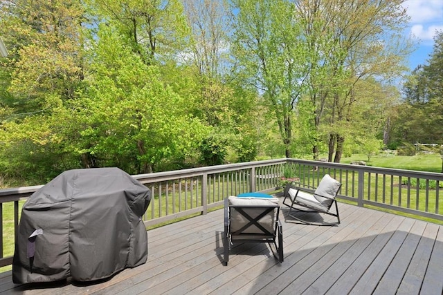 deck featuring grilling area and a lawn