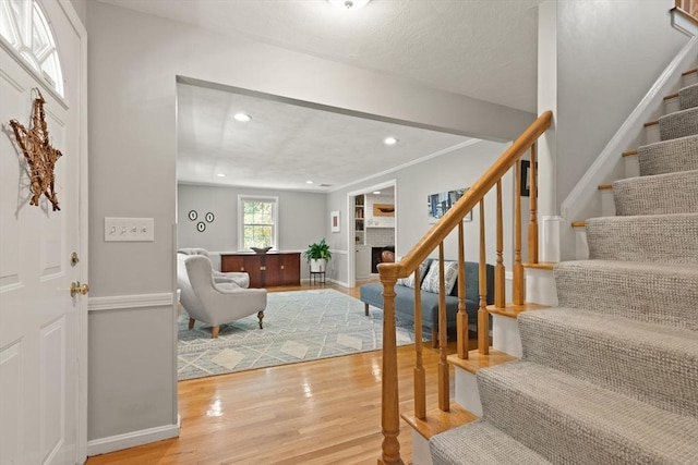 foyer with light wood-style flooring, stairs, recessed lighting, and baseboards