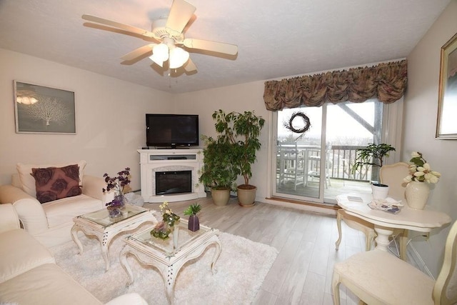 living room featuring light hardwood / wood-style flooring and ceiling fan