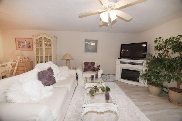 living room with ceiling fan and light hardwood / wood-style floors