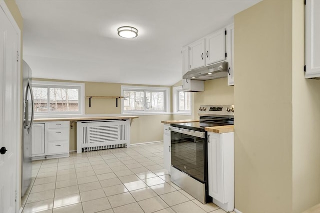 kitchen with stainless steel appliances, white cabinetry, light tile patterned flooring, under cabinet range hood, and baseboards