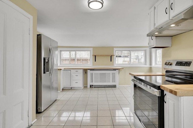 kitchen featuring appliances with stainless steel finishes, light tile patterned flooring, white cabinetry, and under cabinet range hood