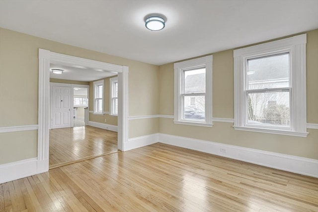 unfurnished room featuring light wood-style floors and baseboards