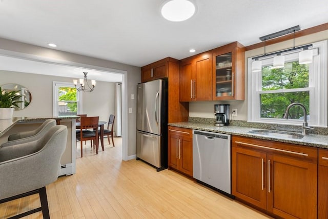 13 Shagbark Rd, Sandwich, MA 02644 - kitchen featuring appliances with stainless steel finishes, a sink, brown cabinets, glass insert cabinets, and recessed lighting