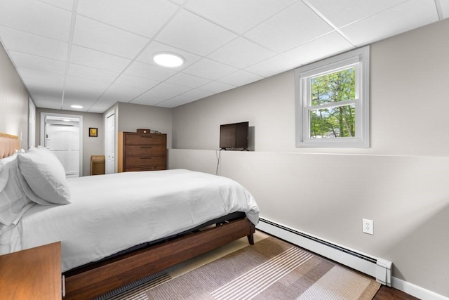 13 Shagbark Rd, Sandwich, MA 02644 - bedroom featuring baseboard heating, a paneled ceiling, and wood finished floors
