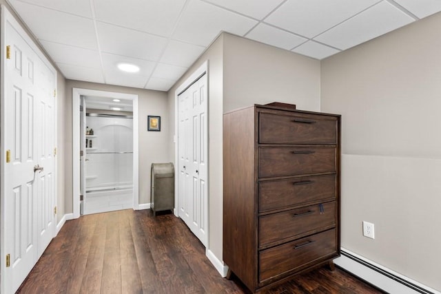 13 Shagbark Rd, Sandwich, MA 02644 - corridor with baseboard heating, a drop ceiling, dark wood-style floors, and baseboards