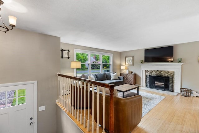 13 Shagbark Rd, Sandwich, MA 02644 - living room featuring a stone fireplace, wood finished floors, and a baseboard heating unit