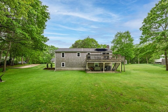 13 Shagbark Rd, Sandwich, MA 02644 - rear view of house with stairway, a deck, a chimney, and a yard