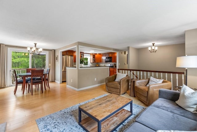 13 Shagbark Rd, Sandwich, MA 02644 - living room featuring a chandelier, light wood finished floors, and baseboards