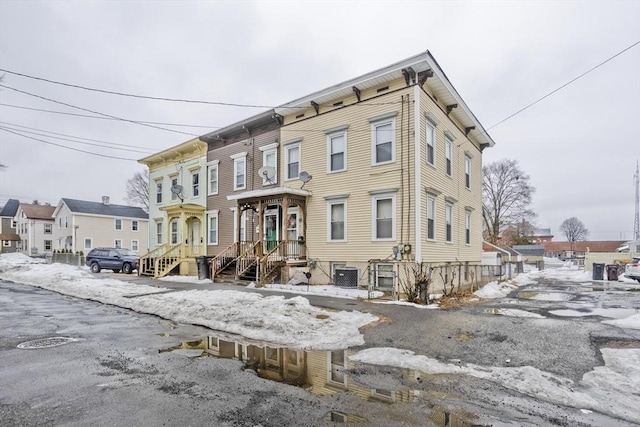 snow covered property featuring central AC