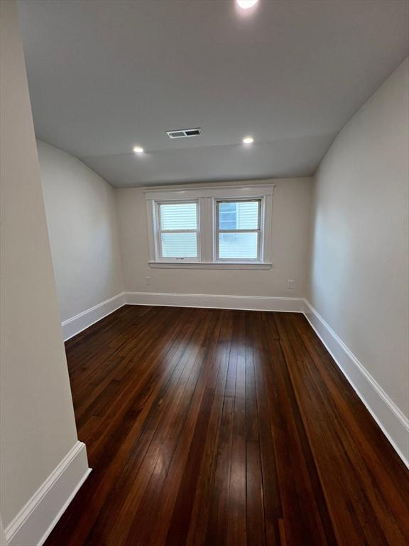 empty room with dark hardwood / wood-style floors