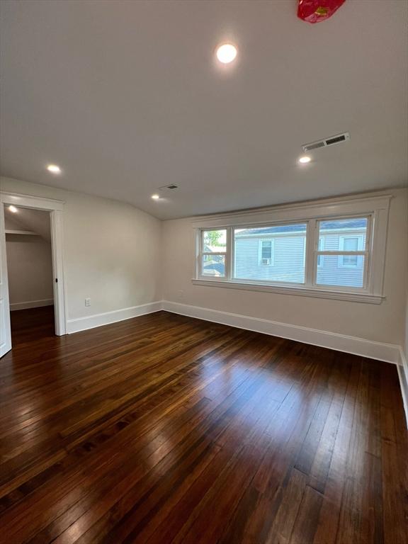 empty room with dark wood-type flooring